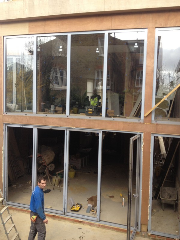 Aluminium bi-fold doors with two-storey glazing in South Woodford