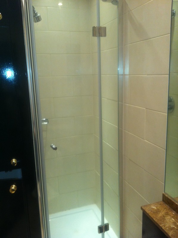 Frameless glass shower enclosure with chrome fittings in South Woodford