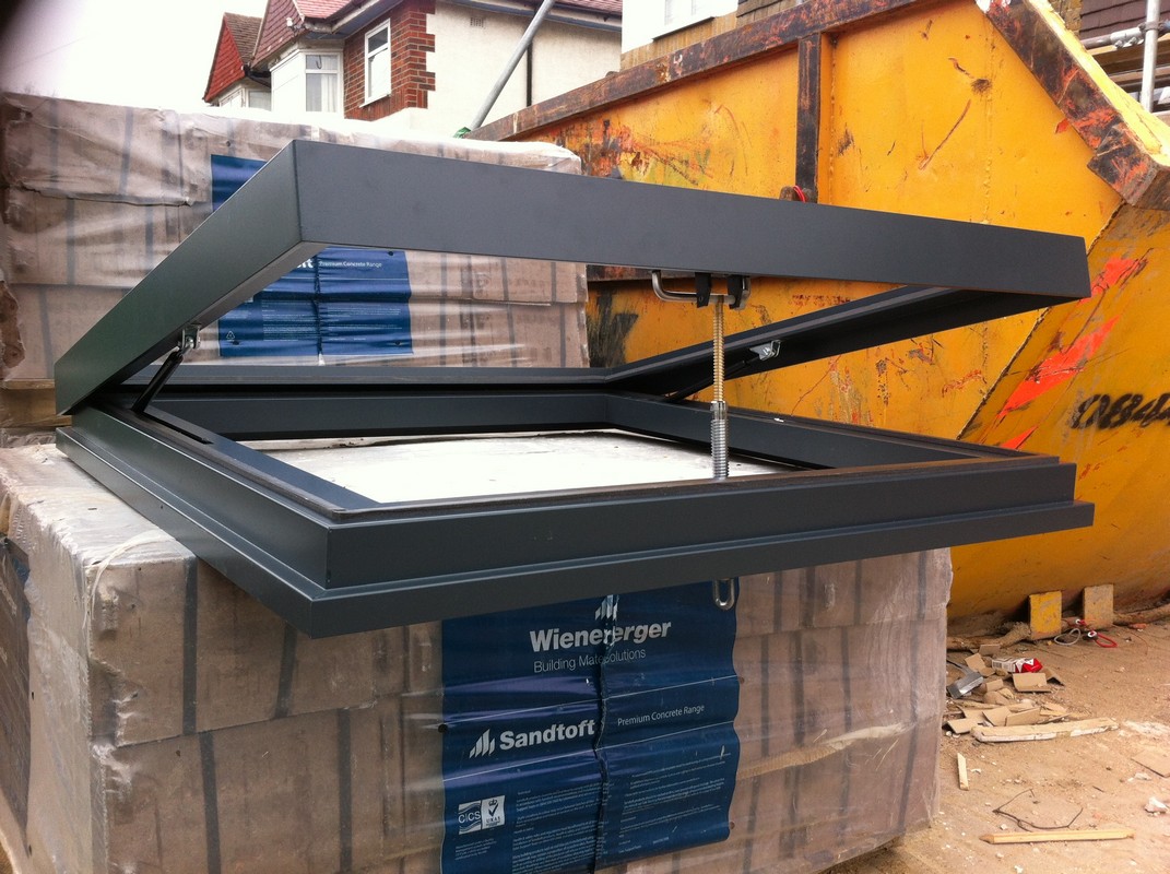 Opening flat roof skylight in anthracite grey installed in South Woodford