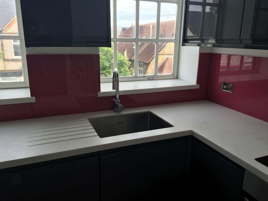 Deep plum coloured glass splashback in modern South Woodford kitchen
